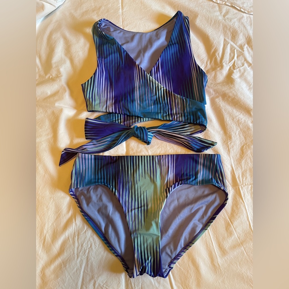 Athleta swimsuit, can be work as cross front or high neck.